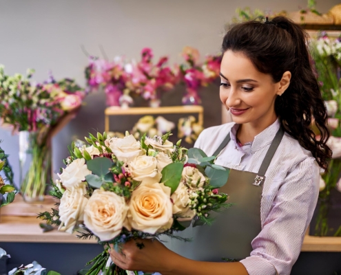Azubi bei Blumen Meister in Frankfurt arrangiert Blumen während der Floristen-Ausbildung.